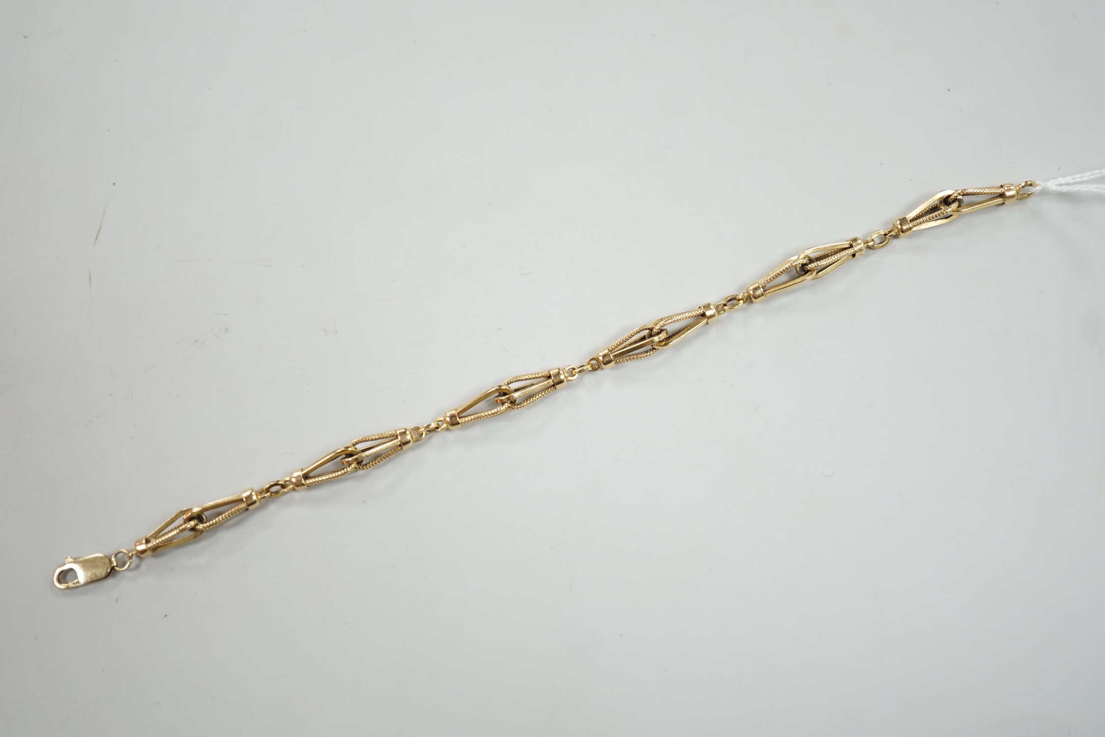 An 18k yellow metal fancy link bracelet with 14k clasp, 21cm, 10.7 grams.